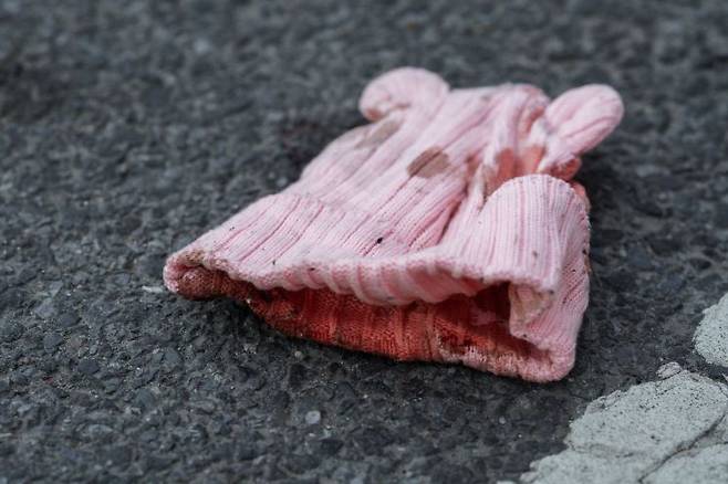 1일(현지시간) 미국 뉴욕 브루클린에서 발생한 총격 사건으로 숨진 생후 7개월 아기의 모자가 바닥에 떨어져 있다. EPA, 연합뉴스