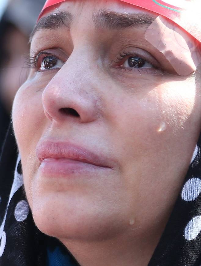 지난달 18일(현지시간) 이란 테헤란에서 미국과 이스라엘에 의해 공습당한 프리깃함의 승조원들과 지도부 인사들의 장례식이 열렸다. 한 여성이 장례식에 참석해 눈물을 흘리고 있다. 신화=연합뉴스