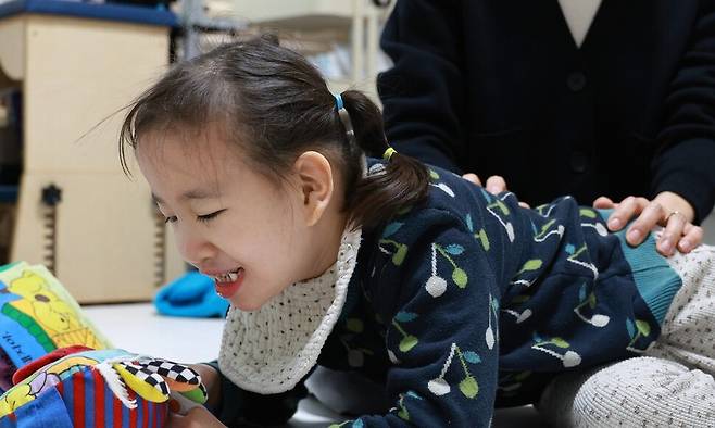 엠마뉴엘 증후군과 뇌병변장애를 겪고 있는 미지(9)양이 지난달 27일 서울 은평구 집에서 좋아하는 인형을 바라보고 있다. 정용일 선임기자 yongil@hani.co.kr