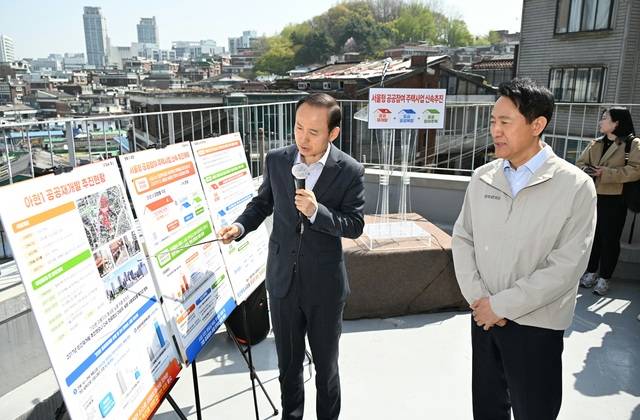 오세훈 서울시장(사진 오른쪽)이 13일 오전 아현1구역 현장 방문을 위해 찾은 마포구 강북노동자복지관에서 사업 설명을 듣고 있다. (서울시 제공)