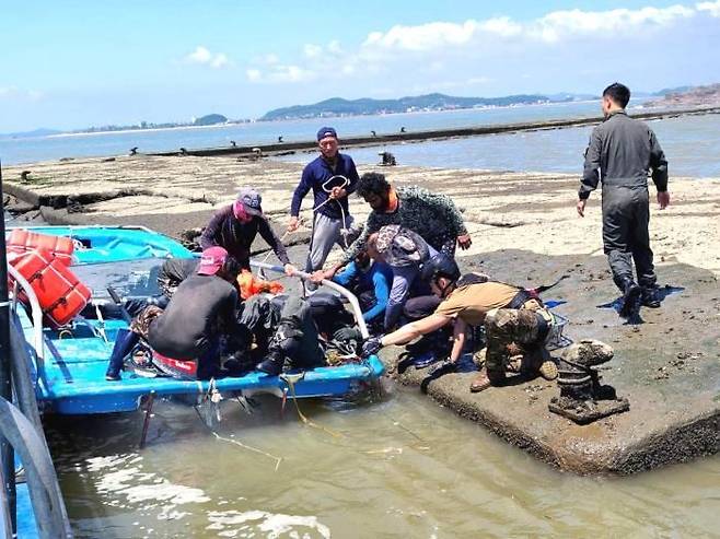 2022년 8월 12일 스리랑카 국적 노동자인 루완 씨와 그의 동료들이 비상탈출한 조종사를 배로 구조한 모습. (사진=안산시 외국인주민상담지원센터 제공). 뉴시스.