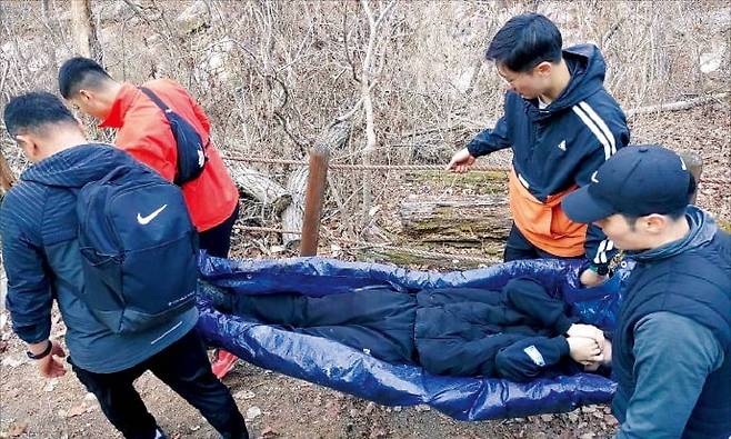 군 간부들이 방수천으로 만든 간이 들것을 활용해 조난자를 이송하고 있다. /56사단 제공