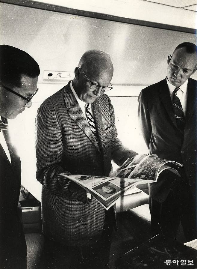 1960년 6월 19일 오끼나와에서 한국을 방문하는 아이젠하워 美 대통령이 비행기안에서 동아일보가 발간한 4.19화보 ‘민주혁명의 기록’을 펼쳐 김주열군의 사체와 고대생들이 깡패에게 습격 당하는 장면을 유심히 보고 있다. 왼쪽은 한국신문편집인협회 대표 특파원인 홍승면 한국일보 편집국장. 〈1960.6.19/최경덕/ 동아일보 DB〉