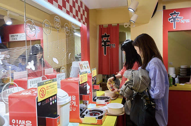 일본 도쿄 하라주쿠 다케시타 거리에 문 연 ‘신라면분식’에서 방문객들이 이른바 ‘한강라면’으로 불리는 즉석조리기로 라면을 직접 끓이고 있다. 농심 제공