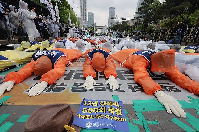 전국장애인부모연대 관계자들이 20일 국회 앞에서 장애인 시설 내 학대 사건의 국정조사, 발달장애인 추경 예산 확보 등을 촉구하는 오체투지를 하고 있다. 연합뉴스