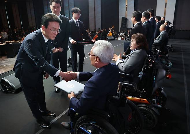 김민석 국무총리가 20일 서울 광진구 비스타워커힐 호텔에서 열린 제46회 장애인의 날 기념식에서 유공자에 대한 포상을 하고 있다. 연합뉴스
