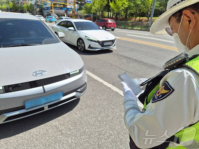 21일 오후 울산북부경찰서 교통경찰이 북구 화봉휴먼시아 앞 사거리에서 빨간불 우회전 시 일시 정지하지 않은 SUV를 잡아 세워 범칙금을 부과하고 있다. 2026.4.21 ⓒ 뉴스1 박정현 기자