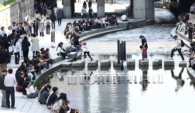 서울 낮 최고 기온이 20도 중반까지 오르는 등 초여름 날씨를 보인 13일 서울 청계천에서 시민들이 여유로운 시간을 보내고 있다. 뉴스1