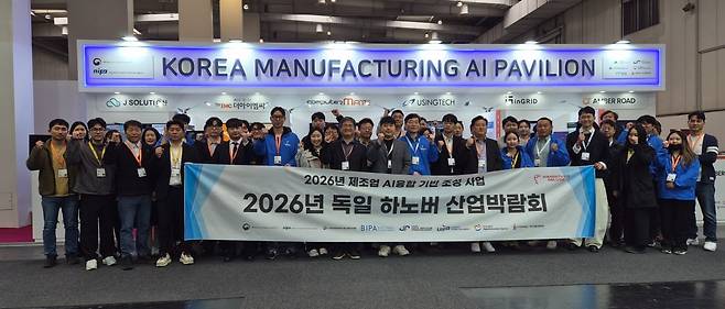 한국 제조 AI 공동관 참가단이 21일 '2026 하노버 산업박람회' 개막 첫날 'KOREA MANUFACTURING AI PAVILION' 앞에서 파이팅을 외치고 있다. 이번 공동관에는 14개 AI 기업과 경남테크노파크, 부산정보산업진흥원(BIPA), 대구디지털혁신진흥원(DIP), 울산정보산업진흥원(UIPA), 포항테크노파크 등 5개 지역 지원기관 관계자를 포함해 약 45명이 참가했다.