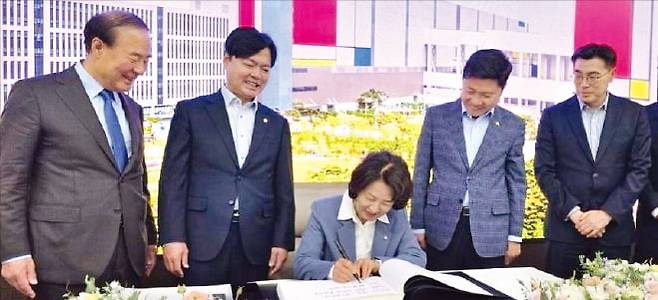 추미애 더불어민주당 경기지사 후보(가운데)가 24일 경기 삼성전자 평택캠퍼스를 찾아 방명록﻿을 쓰고 있다. 왼쪽부터 전영현 삼성전자 부회장, 김현정 민주당 의원, 추 후보, 홍기원 민주당 의원, 최원용 민주당 평택시장 후보.  /추 후보 캠프 제공