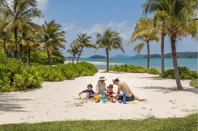 A family plays in the sand on a private beach at Premier Village Phu Quoc Resort in Vietnam. (Sun Group)