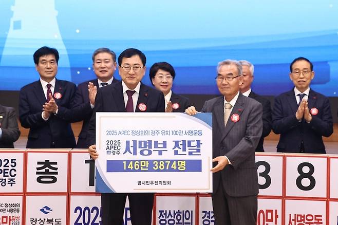 박몽룡 APEC경주유치범시민추진위원장(오른쪽)이 주낙영 경주시장(왼쪽)에게 100만 서명운동 서명부를 전달하고 있다.[경주시 제공]