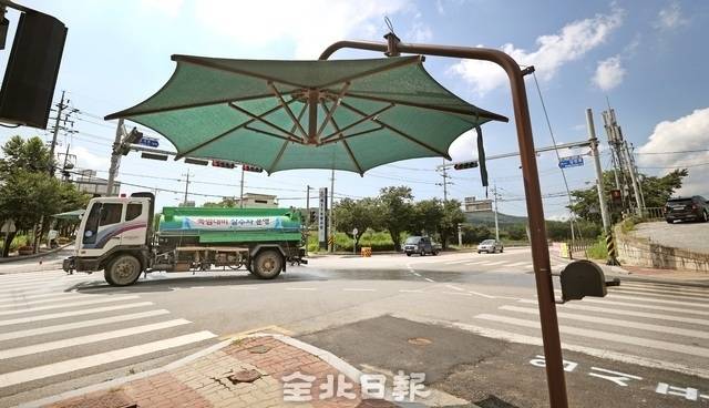 그늘막 앞으로 살수차가 운영되고 있다. /전북일보 DB