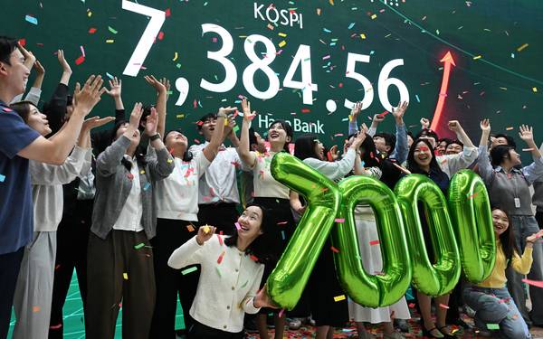 코스피가 전장보다 447.57포인트(6.45%) 오른 7,384.56으로 마감하며 종가 기준 역대 최고치를 경신한 6일 오후 서울 중구 하나은행 딜링룸에서 직원들이 축하 세리머니를 하고 있다. 2026.5.6  /연합뉴스