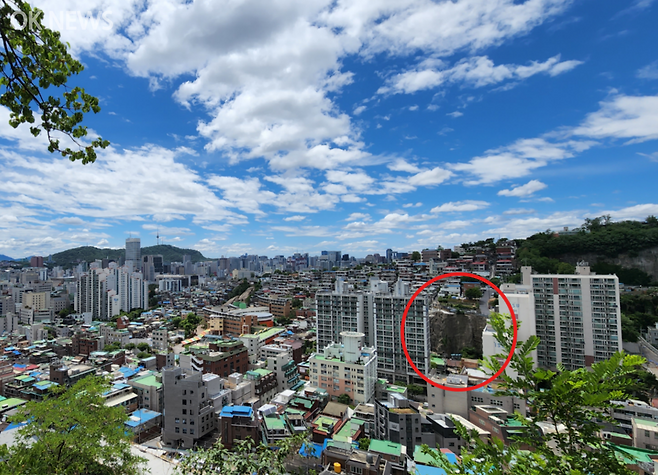 일제가 경성역, 조선총독부를 짓기 위해 낙산 암석을 절개(붉은 원) 부분. 낙산 자락에 3군데의 절개지가 있다.&nbsp; 단종 비 정순왕후의 전설이 깃든 동망봉에서 바라본 모습이다.&nbsp; &nbsp; 사진=전정희 기자