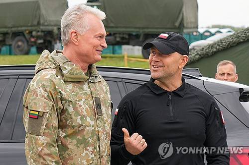 나토 훈련장에서 만난 카롤 나브로츠키 폴란드 대통령(오른쪽), 기타나스 나우세다 리투아니아 대통령 [로이터=연합뉴스]