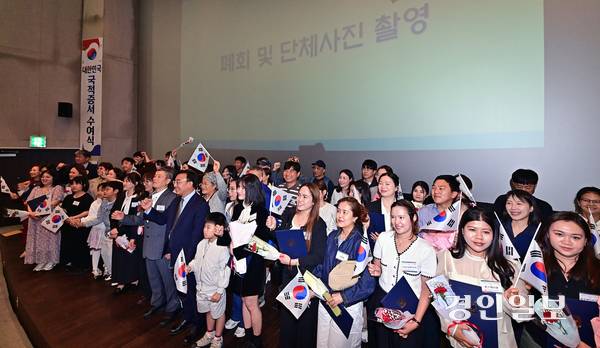 지난 8일 오후 인천 송도국제도시 인천도시역사관에서 열린 ‘대한민국 국적증서 수여식’에 참석한 국적 취득자와 가족들이 태극기를 들고 기념촬영을 하고 있다. 2026.5.8 /조재현기자 jhc@kyeongin.com