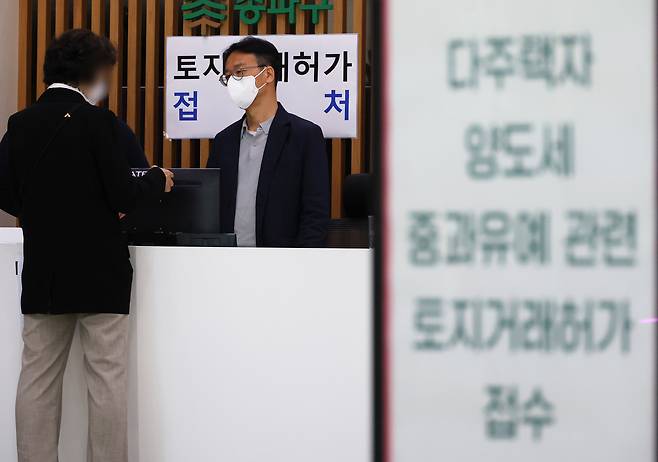 다주택자 양도소득세 중과 유예 종료일인 9일 서울 송파구청을 찾은 민원인들이 토지거래허가 임시 접수처에서 관계 공무원과 상담하고 있다. 연합뉴스