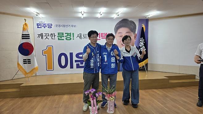 17일 더불어민주당 이윤희 문경시장 후보 선거사무소 개소식에서 이윤희 후보(가운데)가 시의원으로 출마한 임휘철 후보(왼쪽), 임미애 도당위원장과 화이팅을 외치고 있다. /고성환 기자