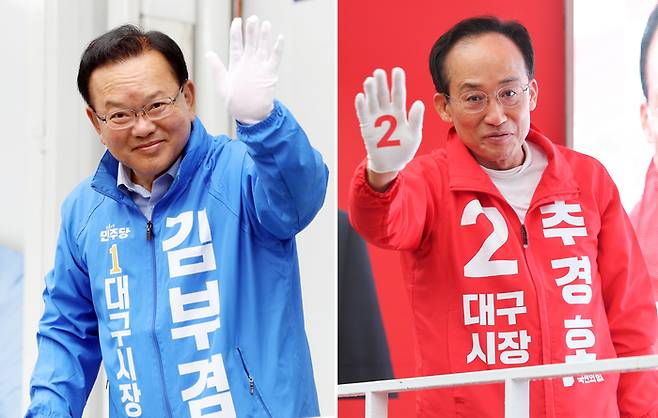 김부겸 더불어민주당 대구시장 후보(왼쪽)와 추경호 국민의힘 대구시장 후보가 지난 21일 대구 범어네거리와 반월당사거리에서 출근길 인사를 하고 있다. [연합뉴스]