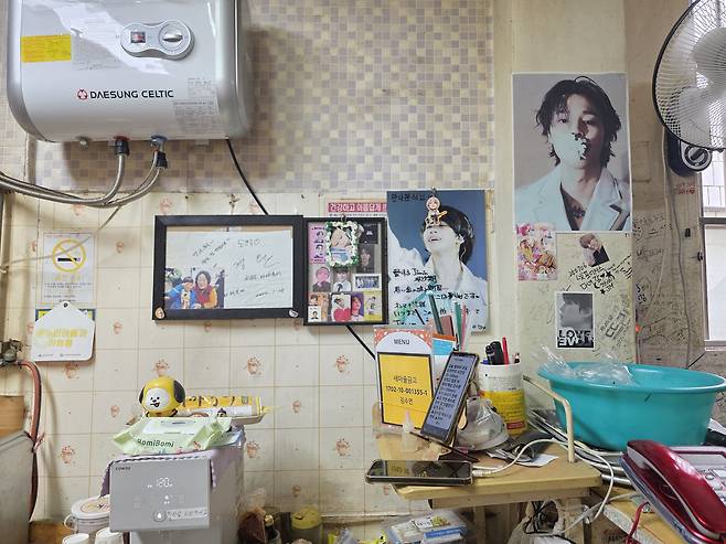 A wall at a diner called Matna Bunsik is adorned with photos of BTS member Jimin gifted by fans. [JIN EUN-SOO]