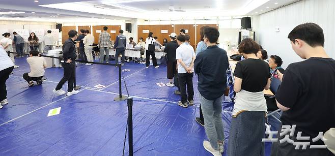 제9회 전국동시지방선거 사전투표 첫날인 지난 29일 서울 용산구 이촌1동 주민센터에 마련된 사전투표소를 찾은 유권자들이 소중한 한 표를 행사하기 위해 줄을 서고 있다. 류영주 기자