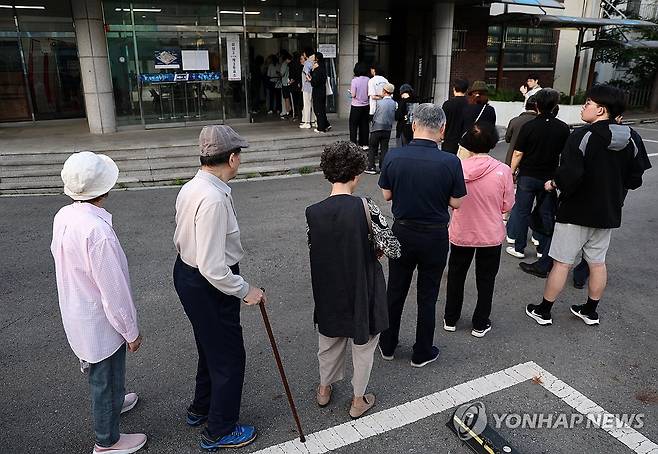 줄 선 유권자들 (서울=연합뉴스) 윤동진 기자 = 제9회 전국동시지방선거일인 3일 유권자들이 서울 언주중학교에 마련된 삼성2동제3투표소에서 투표를 하기 위해 줄을 서 있다. 2026.6.3 mon@yna.co.kr