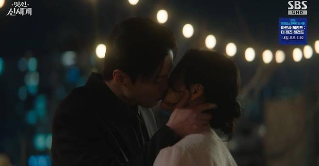 In Brave New World, Heo Nam-joon and Im Ji-yeon shared a passionate kiss amid a crisis, confirming their true feelings for one another.In the ninth episode of the SBS Friday-Saturday drama Brave New World, which aired on the 5th, Cha Se-gye (played by Heo Nam-joon) and Shin Seo-ri (played by Im Ji-yeon) were shown struggling with the revelation of their past lives.At the launch party for the brand B.O.J., Cha Se-gye suddenly asked Shin Seo-ri, Who are you? Gangga Dansim. Who are you? catching her off guard. He then poured out his confusion, saying, A certain woman keeps appearing in my dreams. A palace maid with no friends and no family. At first, I thought it was just a dream. But its strange. That woman looks exactly like you. Am I going crazy?In response, Shin Seo-ri retorted, Who are you to ask me that out of the blue? Did you have a drink in the middle of the day? She added, You cant even tell the difference between a crazy dream and reality. Seeing you show up looking like that and rambling about dreams, youve clearly lost your mind, trying to sound calm while inwardly feeling deeply unsettled.The two kept replaying their conversation over and over in their heads even inside the party hall. Just then, Cha Se-gyes fiancée, Mo Tae-hee (played by Chae Seo-an), appeared and asserted her claim, saying, What are you doing, Se-gye? In an official setting, Im the one who— Shin Seo-ri calmly retorted, Right, youre his fiancée. Ill give you permission, so go hold his hand and take a lap.When Cha Dal-su (played by Yoon Joo-sang), Cha Se-gyes grandfather and the chairman, appeared shortly after, Shin Seo-ri pulled out all the stops with her charm, calling him Grandpa and engaging in a battle of wits with his fiancée, Mo Tae-hee. Cha Se-gye tried to stop them by saying, Enough already, which drew laughter from everyone. Shin Seo-ri retorted, You used to nag me to call you CEO at first, so is being so sensitive about titles like an old fogey a family trait?Later, while reviewing the script for the drama *Queen of Women 2*, in which Shin Seo-ri stars, Cha Se-gye discovered a scene depicting Joo-sang and the noblewomans consummation and flew into a rage. He threw the script down and ordered, Director Son, contact the advertising team. Now, and, leveraging his massive product placement budget, had the entire scene replaced with a silk-rearing ceremony scene that included indirect advertising for cosmetics.Cha Se-gye even visited the set in person and warned the male lead (played by Ahn Chang-hwan), Im the one whos poured a lot of money into this drama, so I have a question. Are you sure the intimate scene with Shin Seo-ri has been cut? He added, There wont be any intimate scenes from now on. So please refrain from any unnecessary physical contact. When the co-star asked who she was, she caused an uproar with the absurd reply, Me? Shin Seo-ris stalker.When Shin Seo-ri, seeing this, scolded him, What am I supposed to do if you keep barging in like this without warning? Cha Se-gye explained, I think Im so stressed from worrying about every little thing that Im even having dreams about it. I need to live more comfortably, explaining that he had changed the script to protect the actress from the troublemaker. When Shin Seo-ri thanked him, saying, Thanks to you, I nailed that scene, Cha Se-gye retorted, Just words? He then snatched the eye-shaped candy Shin Seo-ri had pulled out, popped it into his mouth, and smiled, remarking, Its disgustingly sweet.Later, Cha Se-gye underwent surgery to have his impacted wisdom tooth extracted. Under anesthesia on the operating table, he had a dream about the past once again. In the dream, Lee Hyun, longing for Gang Dan-sim, wrote a poem and muttered, I just cant bring myself to tell her this. When Cha Se-gye woke up from the anesthesia and didnt see Shin Seo-ri by his side, he was disappointed, calling her a heartless woman, but soon spotted Shin Seo-ri, who had walked through the rain with bare hands to buy ice for him, and his face lit up with relief.Shin Seo-ri, troubled by the dream Cha Se-gye had mentioned, asked him about its contents, and he replied, He called me Grand Prince. Realizing that the Grand Prince Lee Hyun from her past was actually Cha Se-gye, Shin Seo-ri despaired, thinking, A bad feeling is never wrong. Contrary to her expectation that Grand Prince Lee Hyun would have resented her, Cha Se-gye sincerely told her, He was in love with a woman named Gang Dan-sim, making Shin Seo-ris heart skip a beat.Cha Se-gye dropped a bombshell, saying, Ill take care of Grandfather and settle the political marriage myself. When Shin Seo-ri sarcastically retorted, Are you giving up already? Why not milk it for all its worth? You seem really scared of Grandpas reaction, to which she bluntly confessed, Hes just doing that to look good in your eyes.Before heading home, Shin Seo-ri warned, Be careful of Choi Moon-do (played by Jang Seung-jo). Dont trust anyone, she warned. When Cha Se-gye brushed it off, saying, Ill handle it myself, she offered concerned advice: Do you think the world is that easy? You dont know when or where a knife might strike—do you really want to play at love so carefree? Cha Se-gye retorted, The world is easy for me. But youre the one whos hard. Just dont show up in my dreams, to which Shin Seo-ri asked, What if its not a dream? What if Im that kind of woman? A woman who would give up anything to survive? leaving Cha Se-gye unsettled.Shin Seo-ri visited the history museum and fell deep in thought while looking at the painting she had created. Just then, a student preparing a thesis approached her and showed her a painting in the museum that resembled Shin Seo-ri. This painting depicted a heart-wrenching love letter that Prince Lee Hyun had once left for Gang Dan-sim. Shin Seo-ri wept, saying, Unable to even deliver it, agonizing like a stone, my heart rotting away. What kind of love is that? Love my ass. Then, as if she had made up her mind, she sprinted off at full speed. Unlike her past self, who had foolishly let Lee Hyun slip away, she resolved to charge headlong toward Cha Se-gye in this life.Toward the end of the episode, when Choi Moon-dos hidden camera was discovered, he threatened Cha Se-gye by pulling out a photo of Shin Seo-ri. Cha Se-gye went to find Shin Seo-ri and lashed out at her, asking, Why didnt you tell me you met Choi Moon-do? But in the end, she kissed her, saying, No matter who you are or where you came from, I believe you completely, so forget about all the other guys and just look at me.
