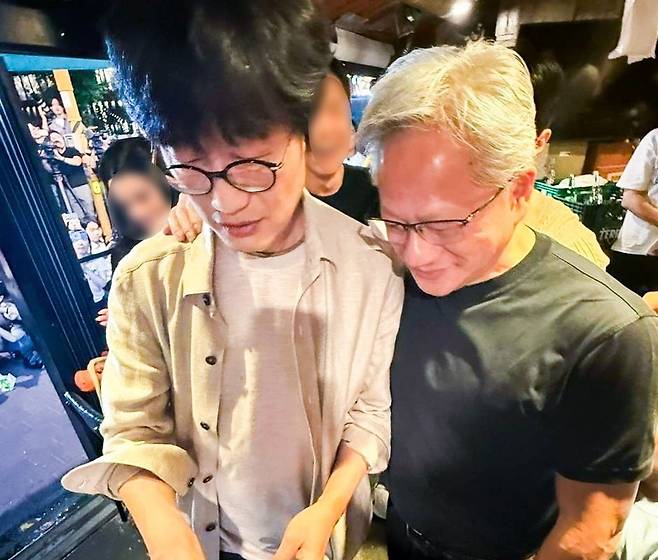 이해진 네이버 의장이 지난 5일 서울 마포구 홍대입구역 인근 식당에서 네이버페이를 통해 결제를 하자 젠슨 황 엔비디아 최고경영자(CEO)가 어깨동무를 하고 있다. 사진=네이버 제공