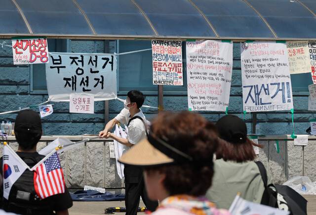 부정선거를 주장하는 시민들이 9일 오전 서울 송파구 올림픽공원 핸드볼경기장 앞에서 투표지 부족 사태를 규탄하며 재선거를 요구하는 집회를 열고 있다. 참가자들은 경기장 주변에 재선거를 촉구하는 유인물을 붙여 놓았다. 류우종 선임기자 wjryu@hani.co.kr