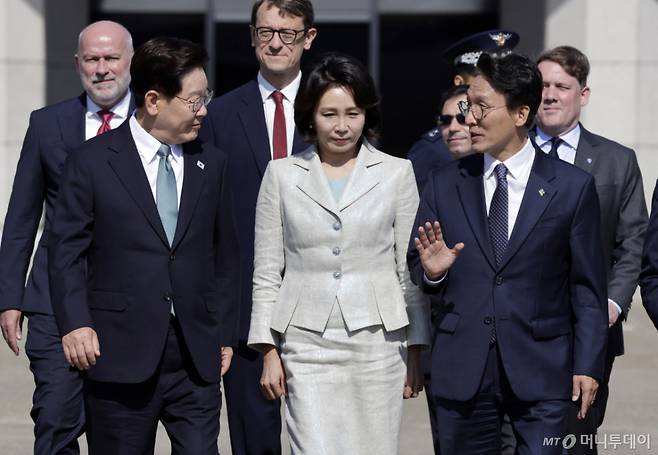 [성남=뉴시스] 최동준 기자 = G7 정상회의 참석 계기 유럽을 방문하는 이재명 대통령과 김혜경 여사가 9일 경기 성남공항에서 공군 1호기로 향하며 김민석 국무총리와 대화하고 있다. 2026.06.09. photocdj@newsis.com /사진=최동준