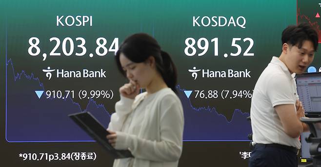 코스피가 10% 가까이 급락해 8200선을 간신히 지키며 마감한 23일 서울 중구 하나은행 딜링룸에서 직원이 업무를 보고 있다. 이날 코스피는 전 거래일 대비 910.71포인트(9.99%) 내린 8203.84로 거래를 마쳤다. 연합뉴스