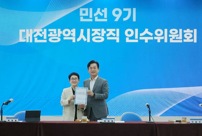 6월 30일 옛 충남도청사에서 열린 민선 9기 대전시장직 인수위원회 마지막 활동보고회에서 박정현 인수위원장이 허태정 대전시장 당선인에서 인수위 분과 활동 보고서를 전달하고 있다. 사진제공은 민선 9기 대전시장직 인수위원회