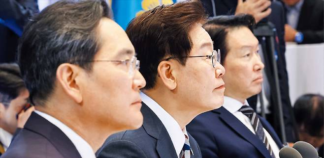 산업장관 발표 듣는 李대통령과 총수들  이재명 대통령(가운데)과 이재용 삼성전자 회장(왼쪽), 최태원 SK그룹 회장이 29일 청와대 영빈관에서 열린 ‘대한민국 대도약 3대 메가프로젝트 국민보고회’에서 김정관 산업통상부 장관의 발표를 듣고 있다. /뉴스1