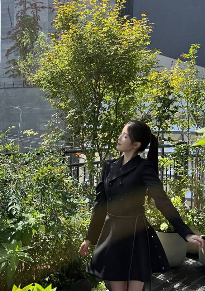 Singer and actress IU shared an official update on her activities for the first time in about two months by attending the handprinting ceremony for the 5th Blue Dragon Series Awards. IU appeared in a neat and polished look, wearing a black mini-jacket dress, delighting her fans.On the 7th, IU attended the handprinting event held at CGV Yongsan IPark Mall in Yongsan-gu, Seoul, where she posed for photos and shared a selfie. IU drew attention with her ponytail hairstyle and stylish outfit, and she sent a message of encouragement to her fans through her official account.This event drew particular attention as it marked IUs first public appearance in about two months following the controversy that arose last May. At the time, IU had posted an apology regarding the drama-related controversy.Fans expressed their delight at hearing from IU after such a long time and sent her enthusiastic support. They left comments on IUs social media posts, showing their unwavering affection and support.