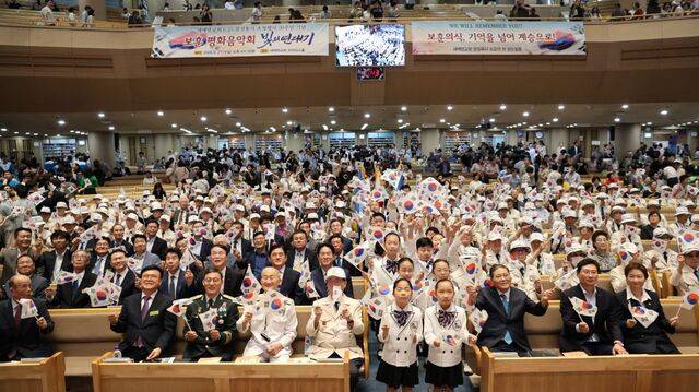 지난달 경기도 용인 새에덴교회에서 열린 보훈음악회 후 참석자들이 태극기를 흔들고 있는 모습. 교회 제공