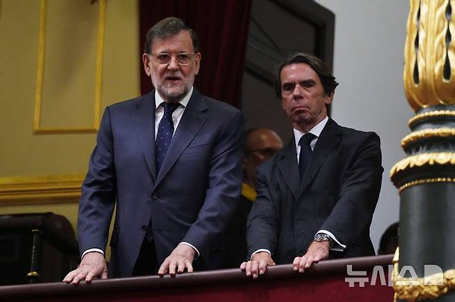 Former Spanish Prime Ministers Mariano Rajoy, left, and Jose Maria Aznar attend a meeting between Pope Leo XIV and members of the Spanish Parliament at the Congress of Deputies, in Madrid, Monday, June 8, 2026. (AP Photo/Alessandra Tarantino)