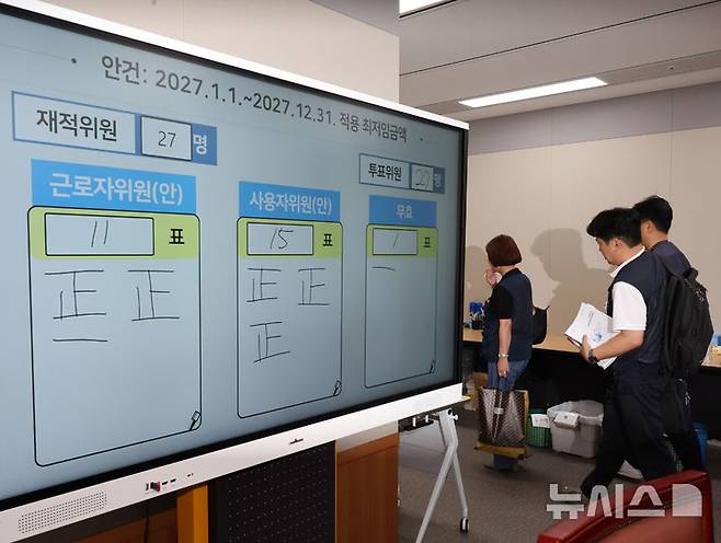 [세종=뉴시스] 배훈식 기자 = 최저임금위원회 근로자 위원들이 지난 14일 오후 세종시 정부세종청사에서 열린 최저임금위 제14차 전원회의를 마친 뒤 회의장을 나서고 있다. 최저임금위는 이날 2027년도 최저임금을 표결에 부쳐 1만700원으로 확정했다. 2026.07.14. dahora83@newsis.com