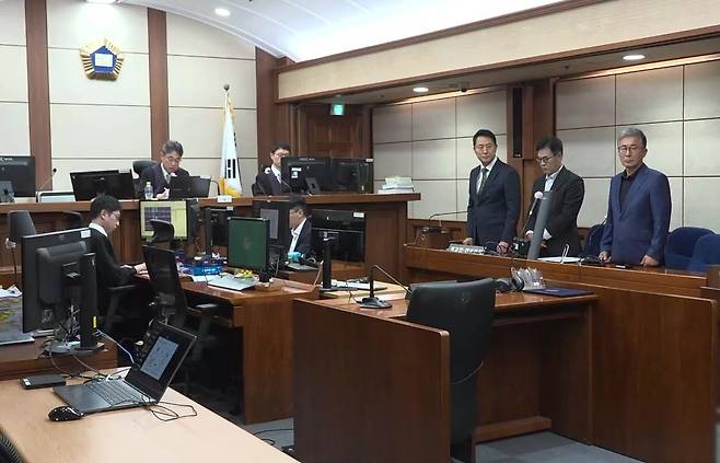 오세훈 서울시장, 강철원 전 서울시 부시장, 사업가 김한정씨(오른쪽 세 번째부터)가 22일 서울 서초구 서울중앙지법에서 열린 정치자금법 위반 사건 1심 공판에서 피고인석에 서서 선고 내용을 듣고 있다. 재판부는 오 시장이 국민의힘 서울시장 경선을 앞둔 2021년 1∼2월 정치브로커 명태균씨에게 5건의 여론조사를 의뢰하고 후원자인 김씨가 비용을 대납했다고 판단했다. 연합뉴스