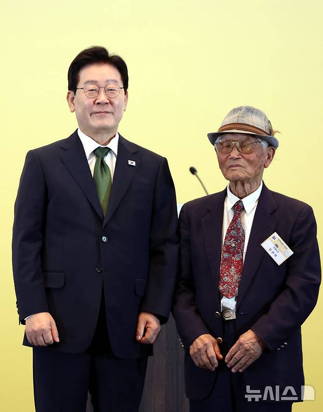 [상파울루=뉴시스] 김진아 기자 = 이재명 대통령이 28일(현지 시간) 브라질 상파울루의 한 호텔에서 열린 동포 오찬 간담회에서 마지막 생존 전쟁포로인 임관택 씨에게 감사패를 전달하고 기념 촬영을 하고 있다. 2026.07.29. bluesoda@newsis.com