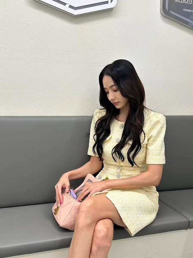 Actress Han Chae-young showcased her unchanging, Barbie Doll-like beauty by sharing everyday photos taken while waiting for filming. Han Chae-young flaunted her radiant visuals by posting behind-the-scenes photos on her social media account.In the released photos, Han Chae-young is wearing a light yellow tweed dress and smiling brightly. Despite being on standby before filming, she captivated viewers with an atmosphere reminiscent of a scene from a movie.Her natural interactions with the staff on set also drew attention. Born in 1980, Han Chae-young drew admiration from fans by displaying both her enduring innocence and sophisticated charm.