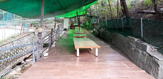 Tables are illegally installed in a valley in Gangbuk District, northern Seoul, in 2019. SEOUL CITY GOVERNMENT