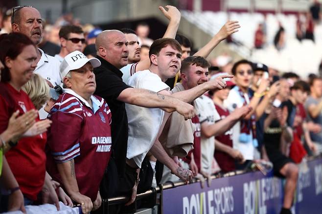 West Ham United's fans react towards their players after the English Premier League football match between West Ham United and Leeds United at the London Stadium, in east London on May 24, 2026. West Ham won the game 3-0 but were relegated due to Tottenham not losing to Everton. (Photo by Henry Nicholls / AFP) / RESTRICTED TO EDITORIAL USE. No use with unauthorized audio, video, data, fixture lists, club/league logos or 'live' services. Online in-match use limited to 120 images. An additional 40 images may be used in extra time. No video emulation. Social media in-match use limited to 120 images. An additional 40 images may be used in extra time. No use in betting publications, games or single club/league/player publications.