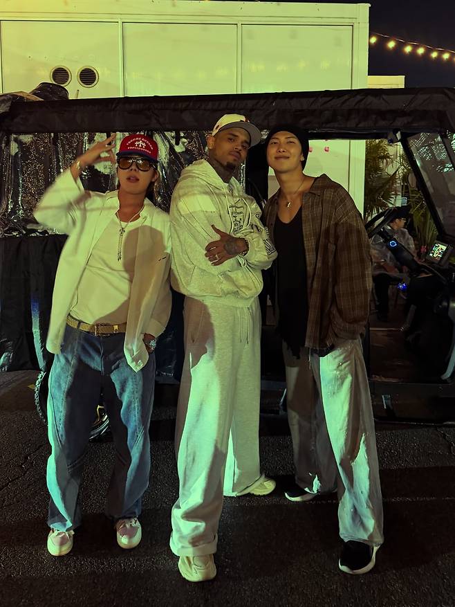 A photo uploaded to Chris Brown's Instagram account on Aug. 14 shows BTS's J-Hope, left, and RM, right, posing with the U.S. singer on Aug. 12. SCREEN CAPTURE