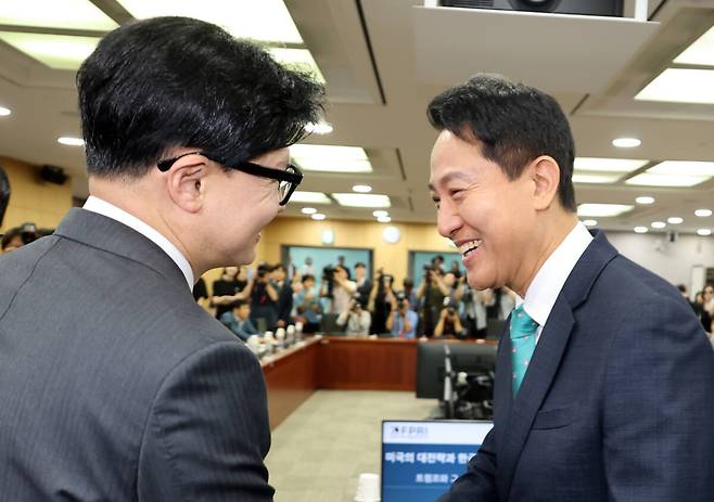 오세훈 서울시장이 25일 국회 의원회관에서 열린 제10차 대한민국 미래혁신포럼 세미나 "미국의 대전략과 한국의 선택"에서 무소속 한동훈 의원을 만나 악수하고 있다. 연합뉴스