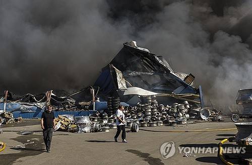 2026년 8월 29일(현지시간) 우크라이나 키이우 인근에서 남성들이 러시아의 공습을 받은 한 물품 창고 현장을 걸어가고 있다. [EPA 연합뉴스. 재판매 및 DB 금지]