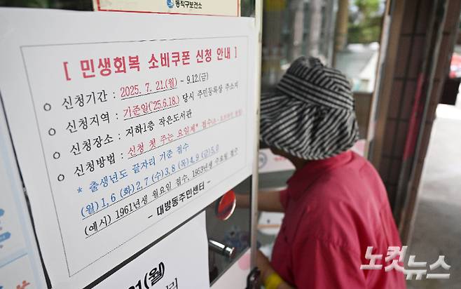 민생회복 소비쿠폰 신청이 시작된 지난해 7월 서울 대방동주민센터에서 한 시민이 소비쿠폰을 신청하기 위해 주민센터로 들어서고 있다. 황진환 기자
