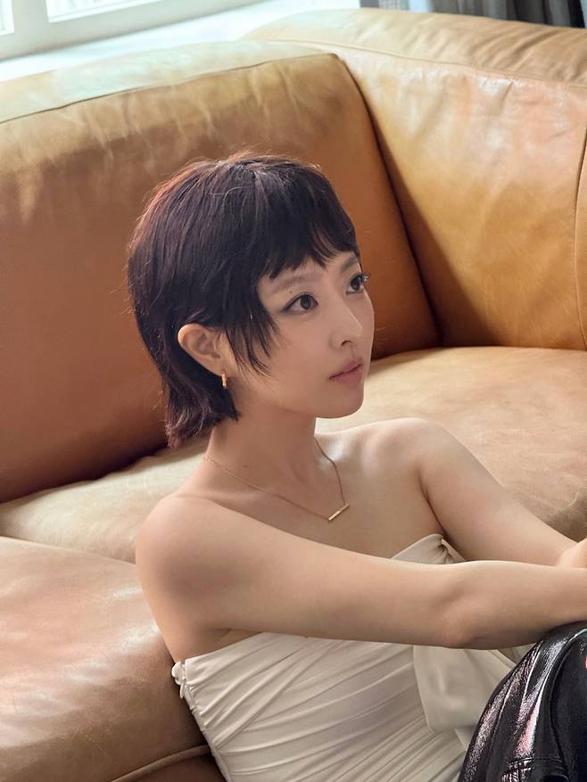 Actress Park Bo-young is drawing attention with a dramatic visual transformation.On the afternoon of the 19th, Park Bo-young posted several photos without any specific explanation.In the released photos, Park Bo-young exuded a distinctly different atmosphere from before with her short haircut. Matching her short hair, which revealed her ears and neckline, with a black sleeveless top that slightly exposed her navel, she revealed a chic yet sophisticated charm.In another photo, she posed leaning against a sofa while wearing a tube top-style outfit. Her sharp eyes combined with a more mature vibe completed a unique visual.In particular, the photos released alongside this one also offered a glimpse of Park Bo-youngs signature elegant charm. With her hair neatly swept back, Park Bo-young wore brown and gray tube top dresses respectively, creating a luxurious atmosphere paired with jewelry.The chic vibe, contrasting with the cute charm for which Park Bo-young has been widely loved for her lovable image, drew admiration.In response, netizens commented, Is she a doll or what?, Anyway, shes pretty, and Park Bo-young is gorgeous.Meanwhile, Park Bo-young, born in 1990 and currently 36 years old, recently delivered a passionate performance as Kim Hee-joo in the Disney+ original series Goldland.Photo = Park Bo-young