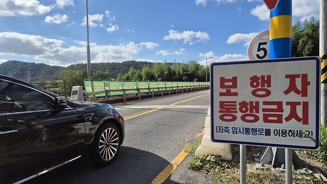 지난 23일 울산 태화강을 가로질러 중구 다운동과 남구 삼호동을 잇는 자동차 전용 다리인 삼호교 한쪽 가장자리에 임시통행로가 마련돼 있는 모습. 지난해 7월 무너진 보행 전용 다리 옛 삼호교를 대신해 주민들이 강을 건널 수 있도록 이렇게 해놓았다. 주성미 기자