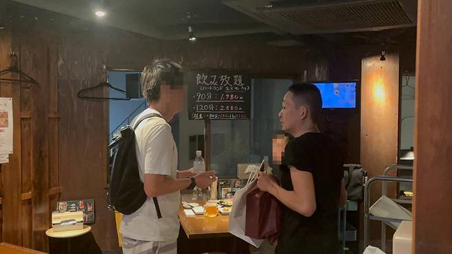 일본 도쿄 간다역 인근에서 한국 음식점을 운영하는 최석진(45)씨가 마지막 영업을 한 지난달 25일 가게에서 단골 손님들과 작별 인사를 나누고 있다. 도쿄=류호 특파원